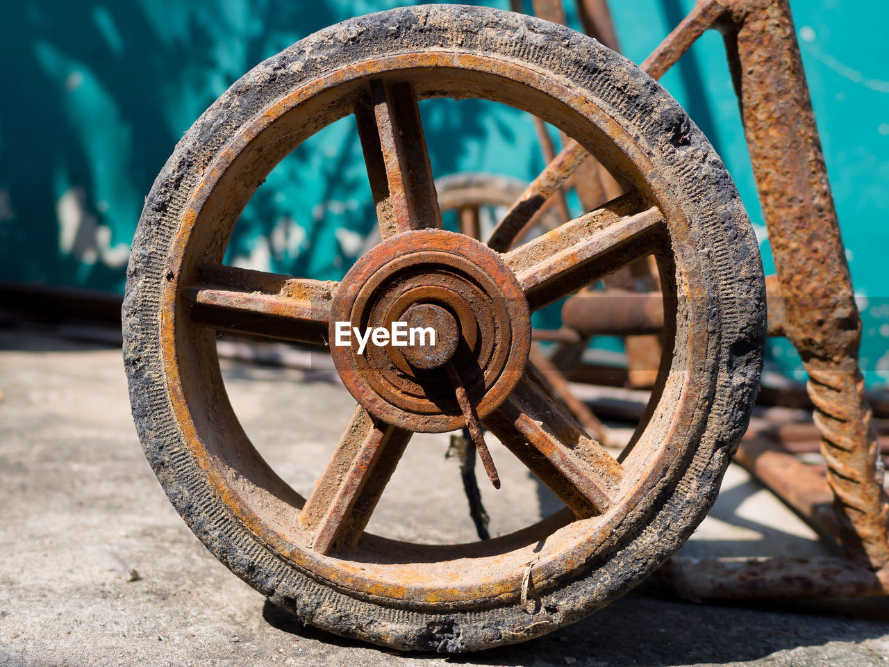 Close-up of rusty wheel on street