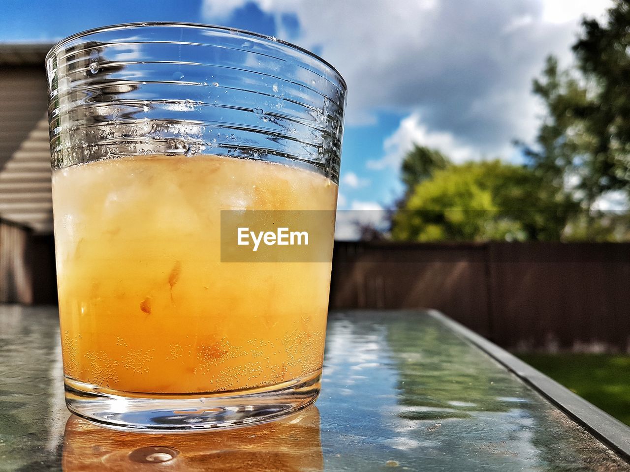 Close-up of orange cocktail on table in back yard