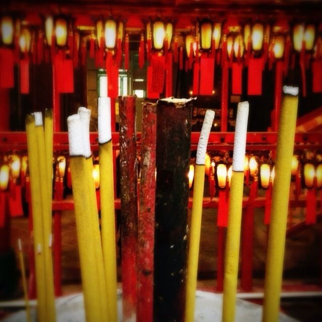 CLOSE-UP OF LIT CANDLES