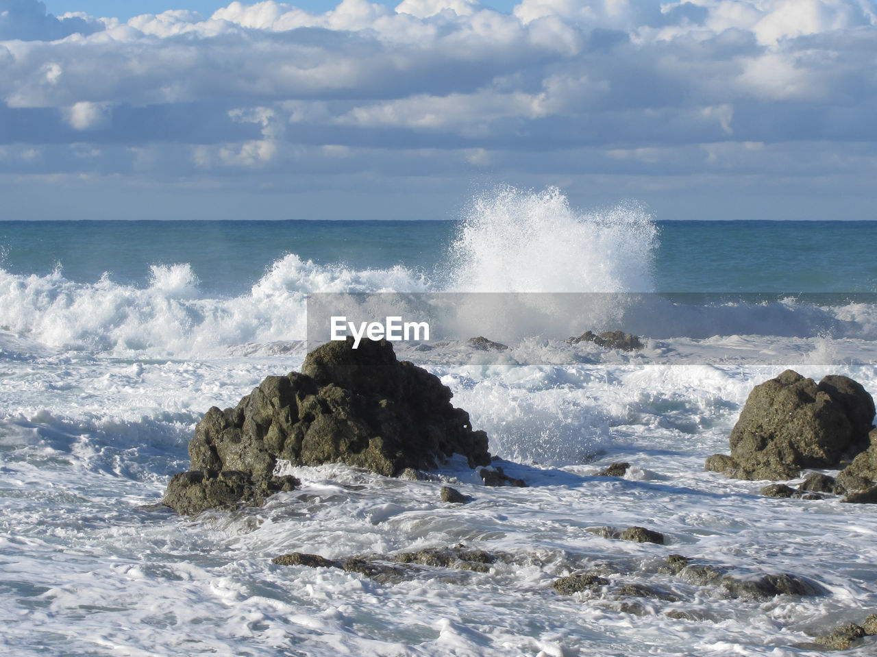 Scenic view of sea against cloudy sky