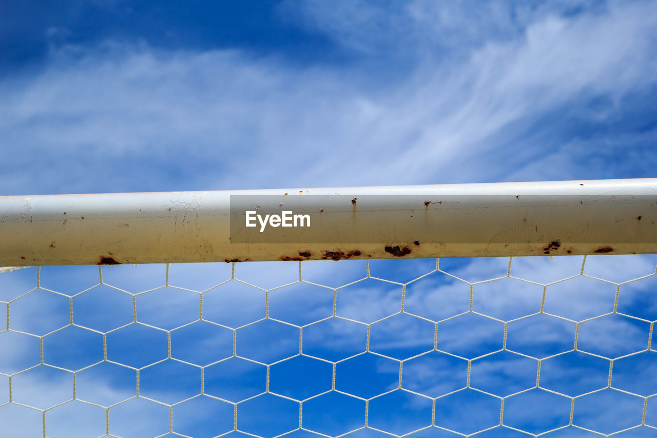 CLOSE-UP OF RAILING AGAINST SKY