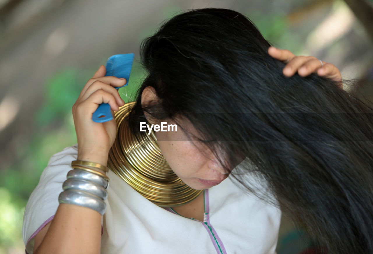 High angle view of woman combing hair