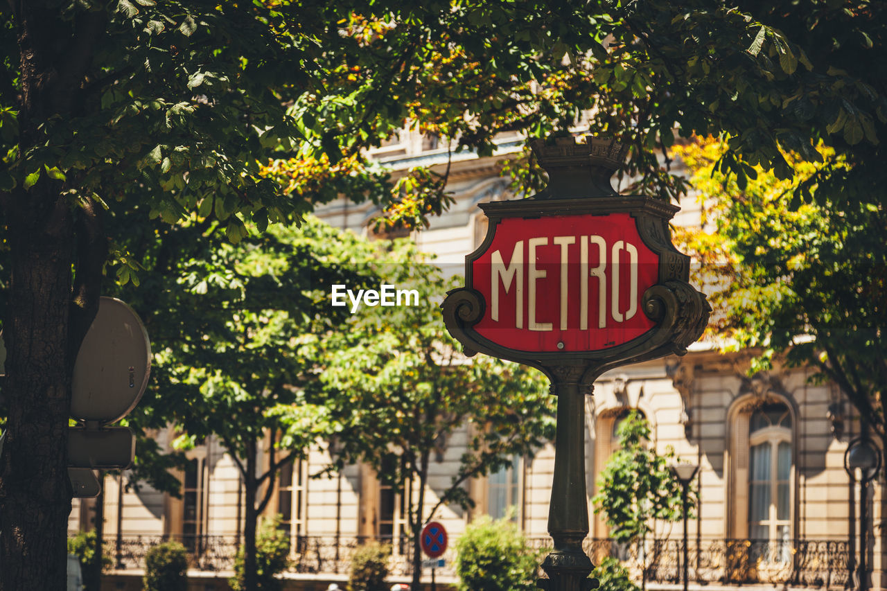 Low angle view of paris metro sign