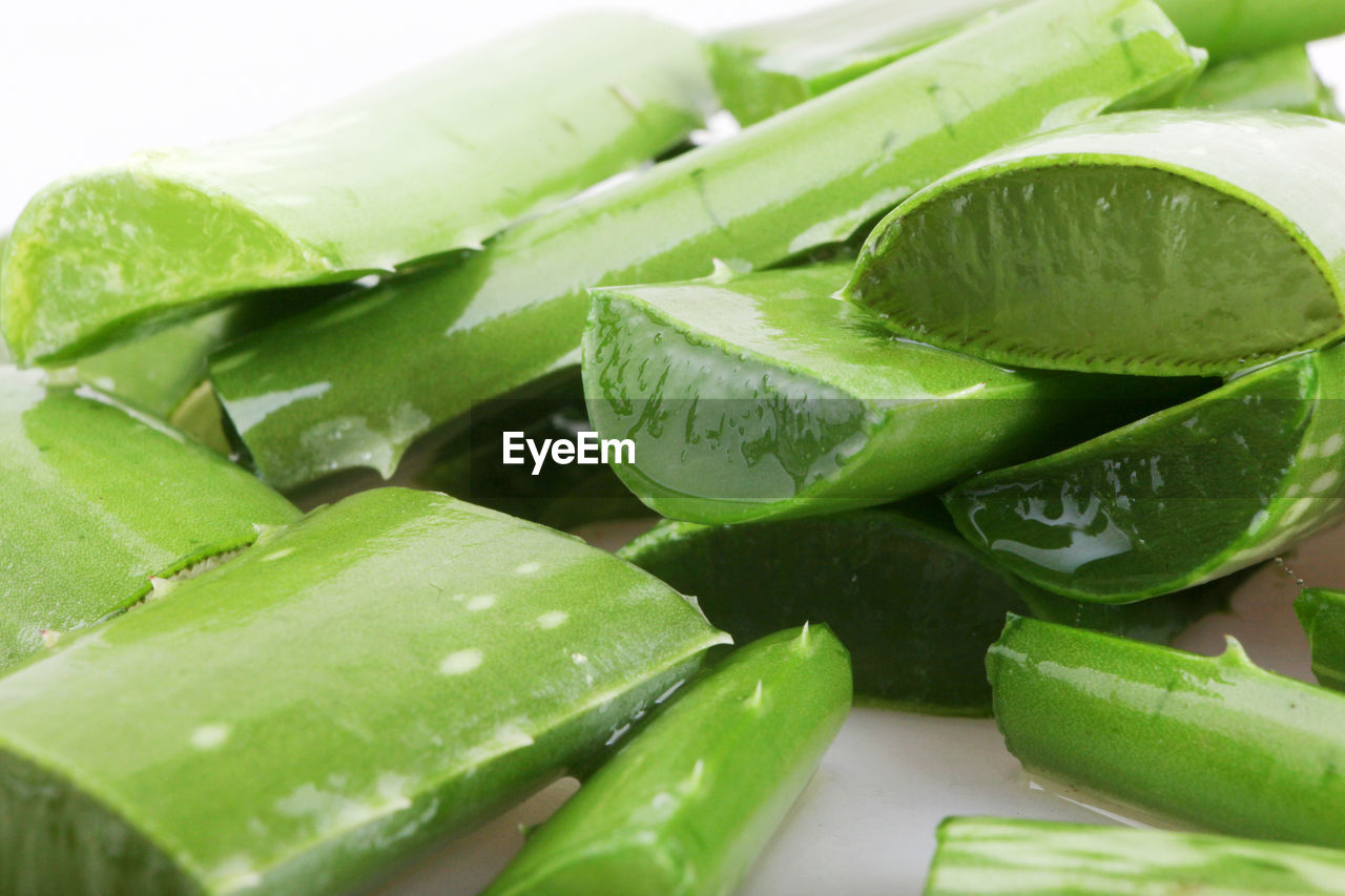 Close-up of aloe vera slices against white background