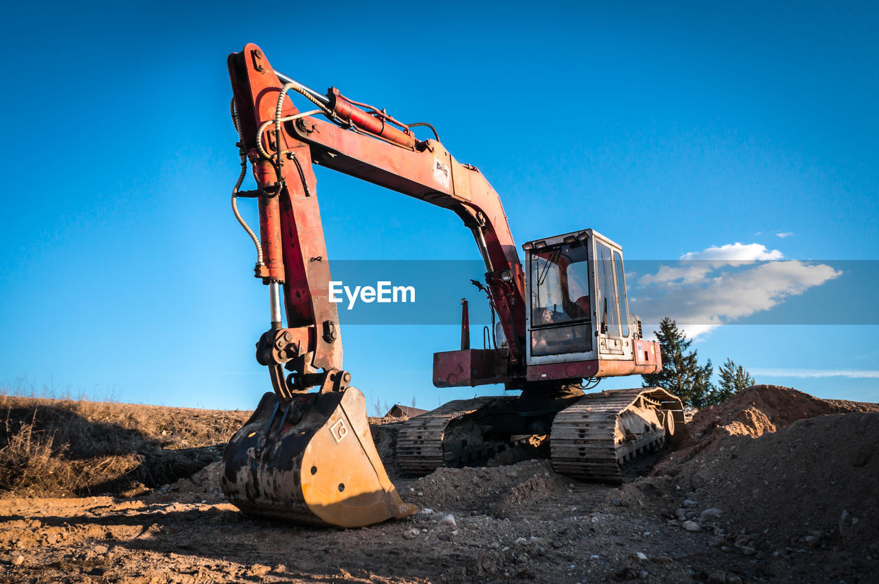 LOW ANGLE VIEW OF CRANE AT CONSTRUCTION SITE AGAINST SKY