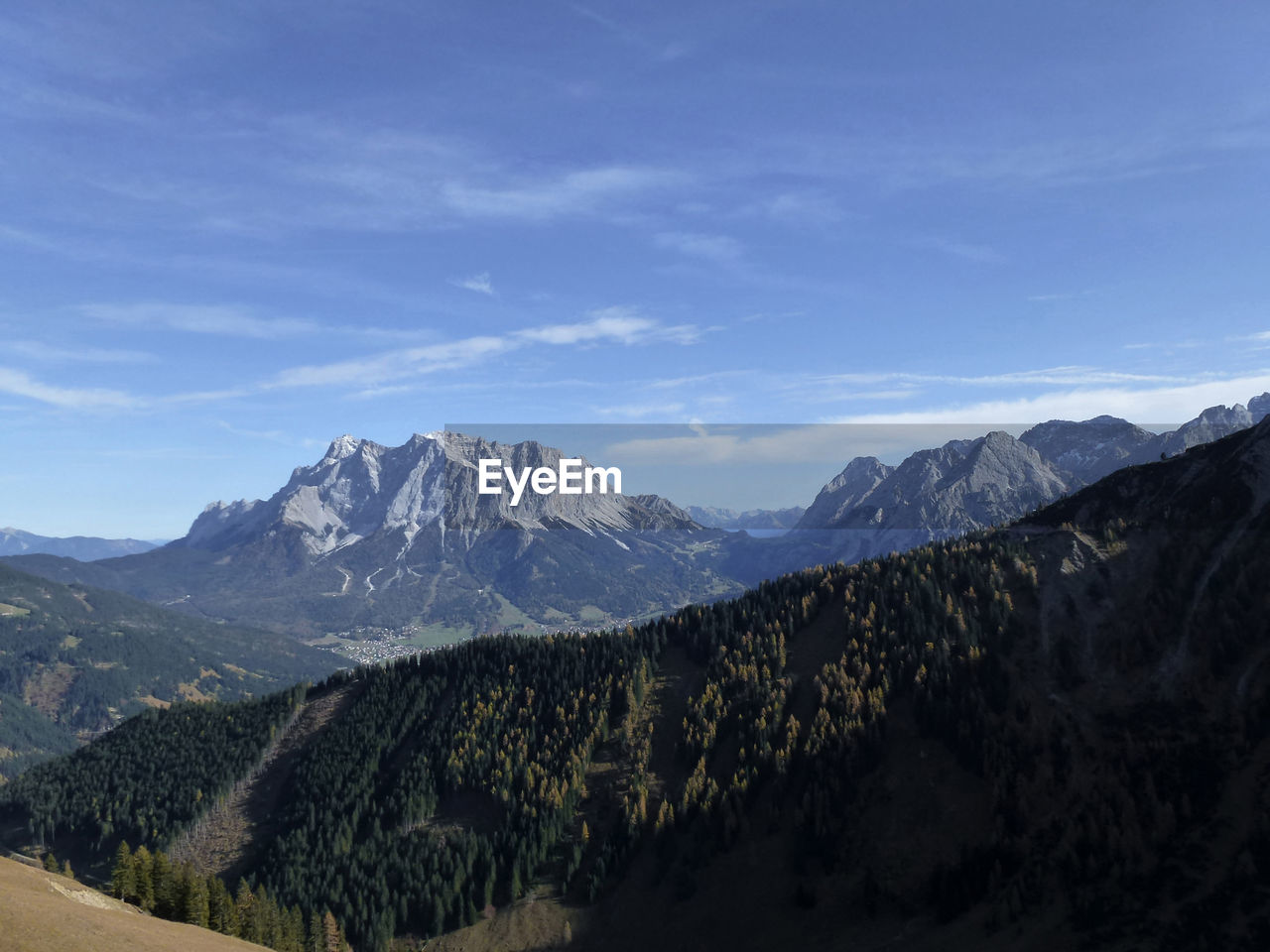 scenic view of snowcapped mountains against blue sky