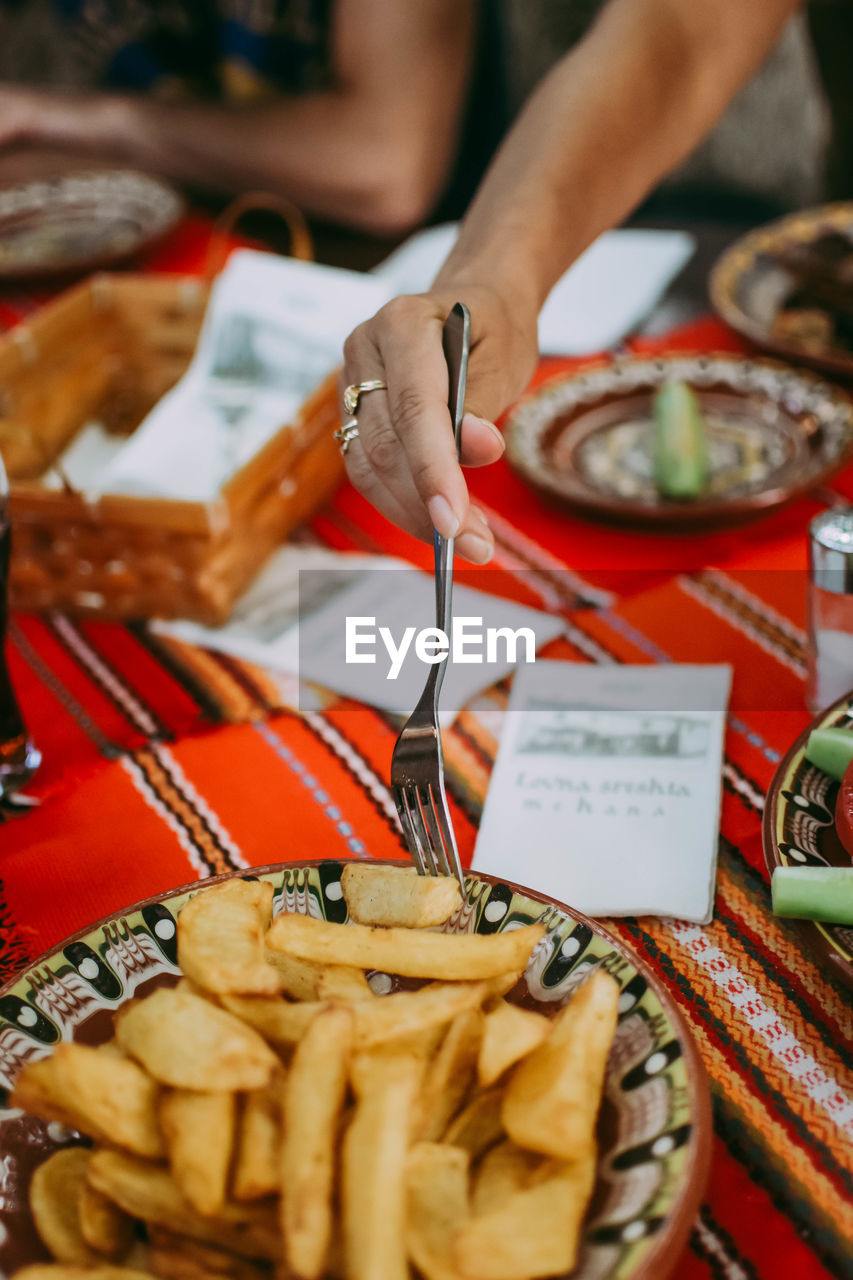 High angle view of hand holding food on table