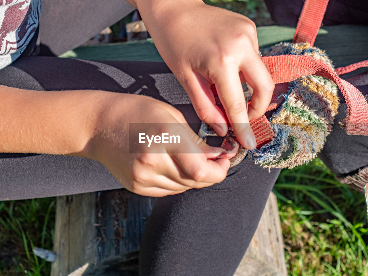 Close-up of child holding belt