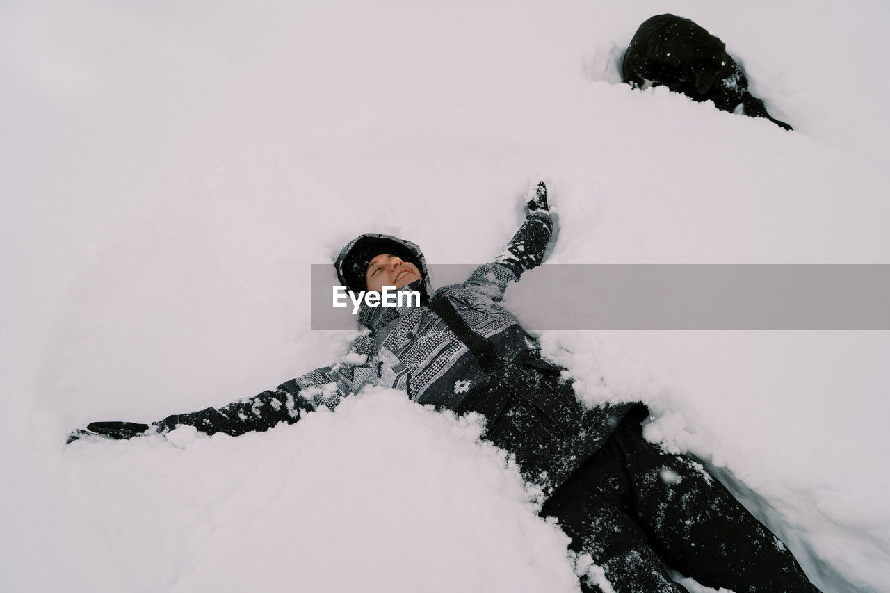 low section of person skiing on snow covered field