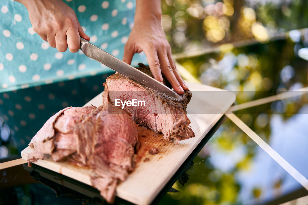 cropped hand of person preparing food on table