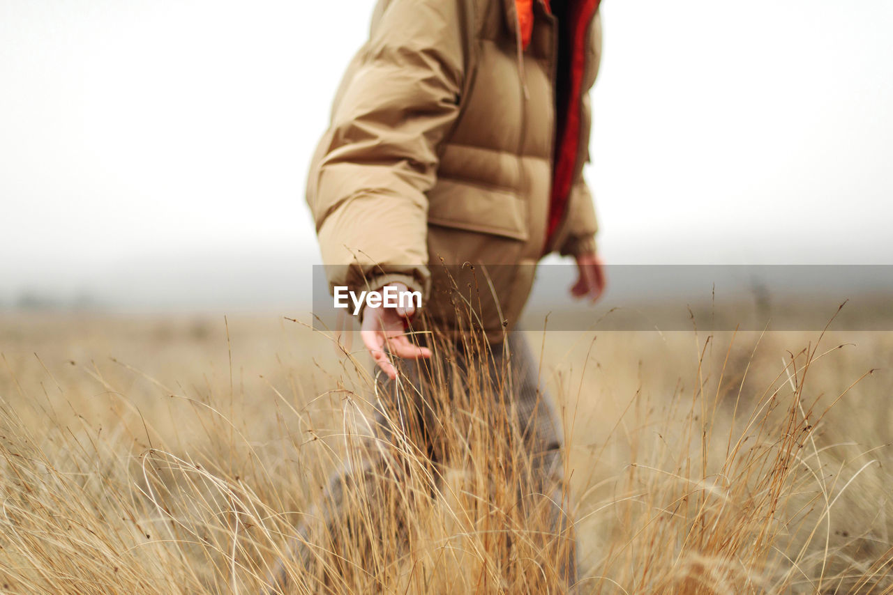 Unrecognizable female hands in autumn grass