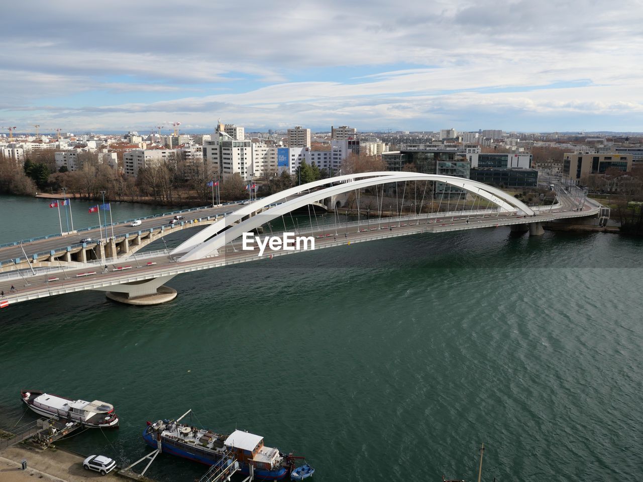 High angle view of bridge over river amidst buildings in city