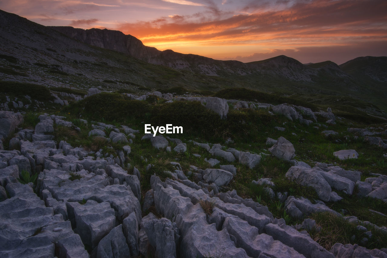 Scenic view of rocky mountains against sky during sunset