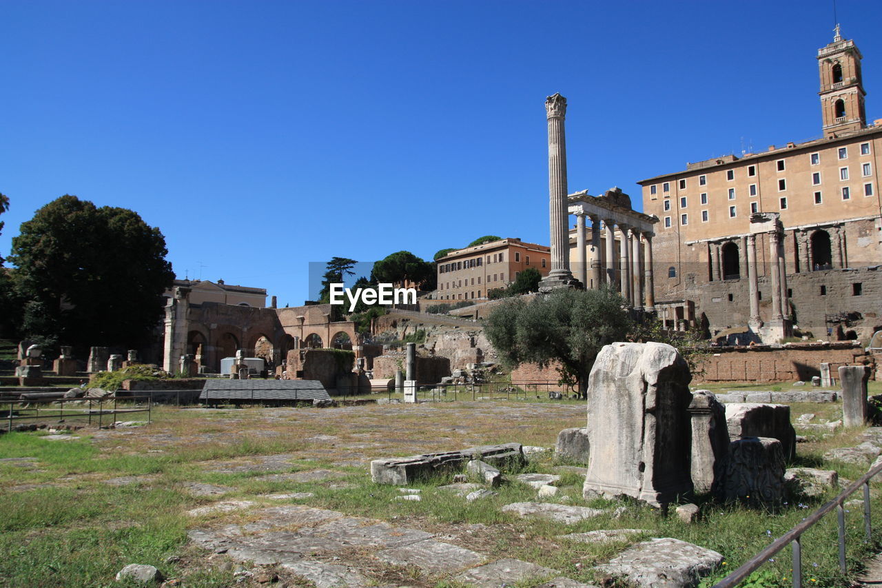 High angle view of old ruins at roman forum against clear blue sky