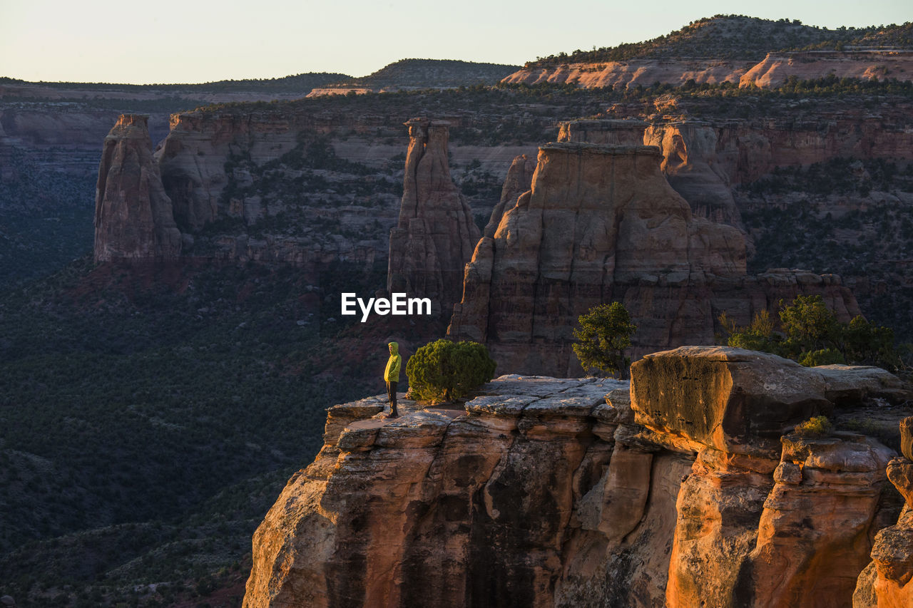 A young woman enjoys a view over colorado national monument in co.