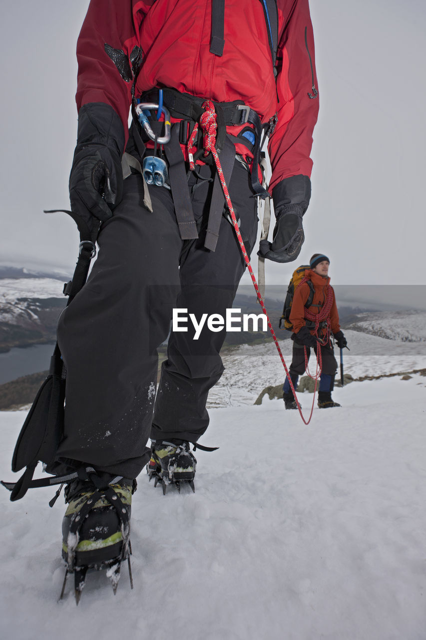 Couple hiking up helvellyn mountain in the lake district