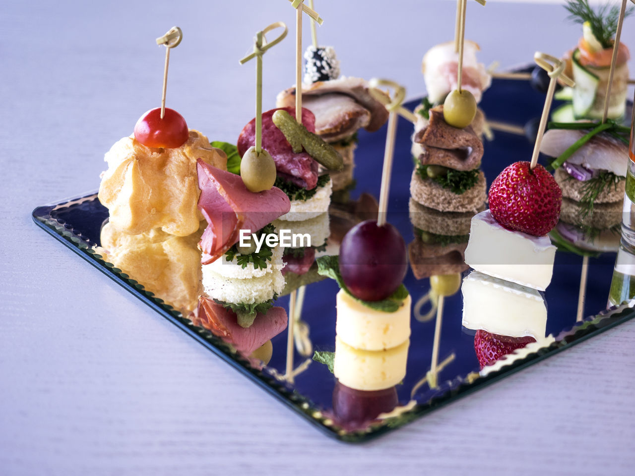 Close-up of various canapes and snacks served on table