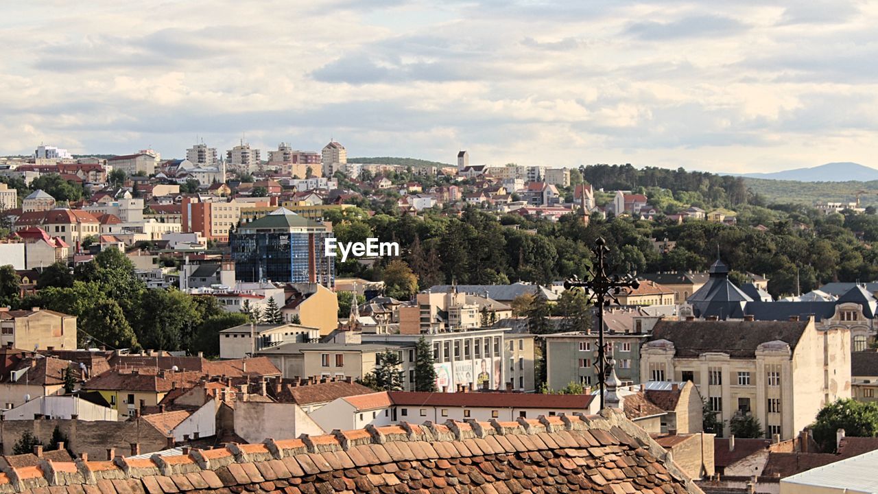 High angle view of houses in town against sky