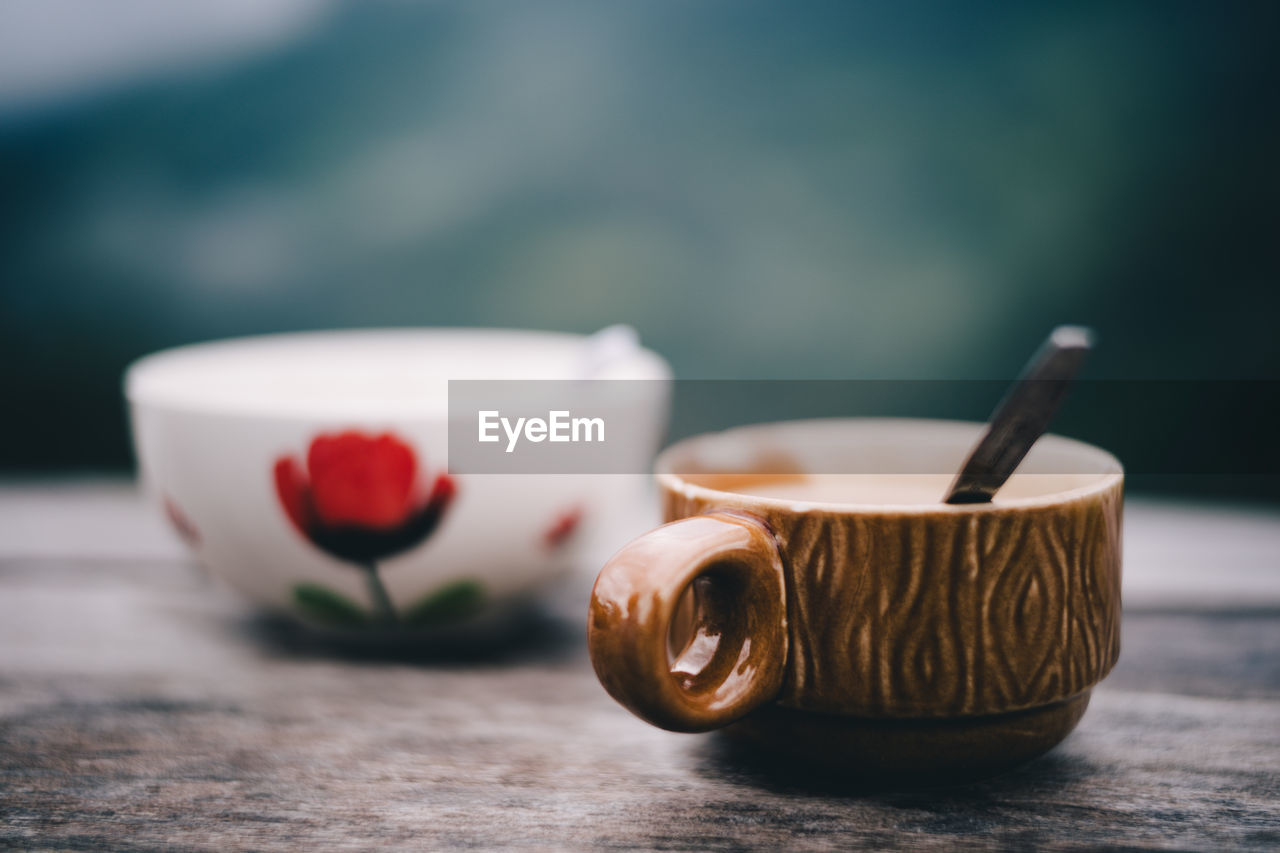 CLOSE-UP OF CUP OF TEA IN GLASS ON TABLE