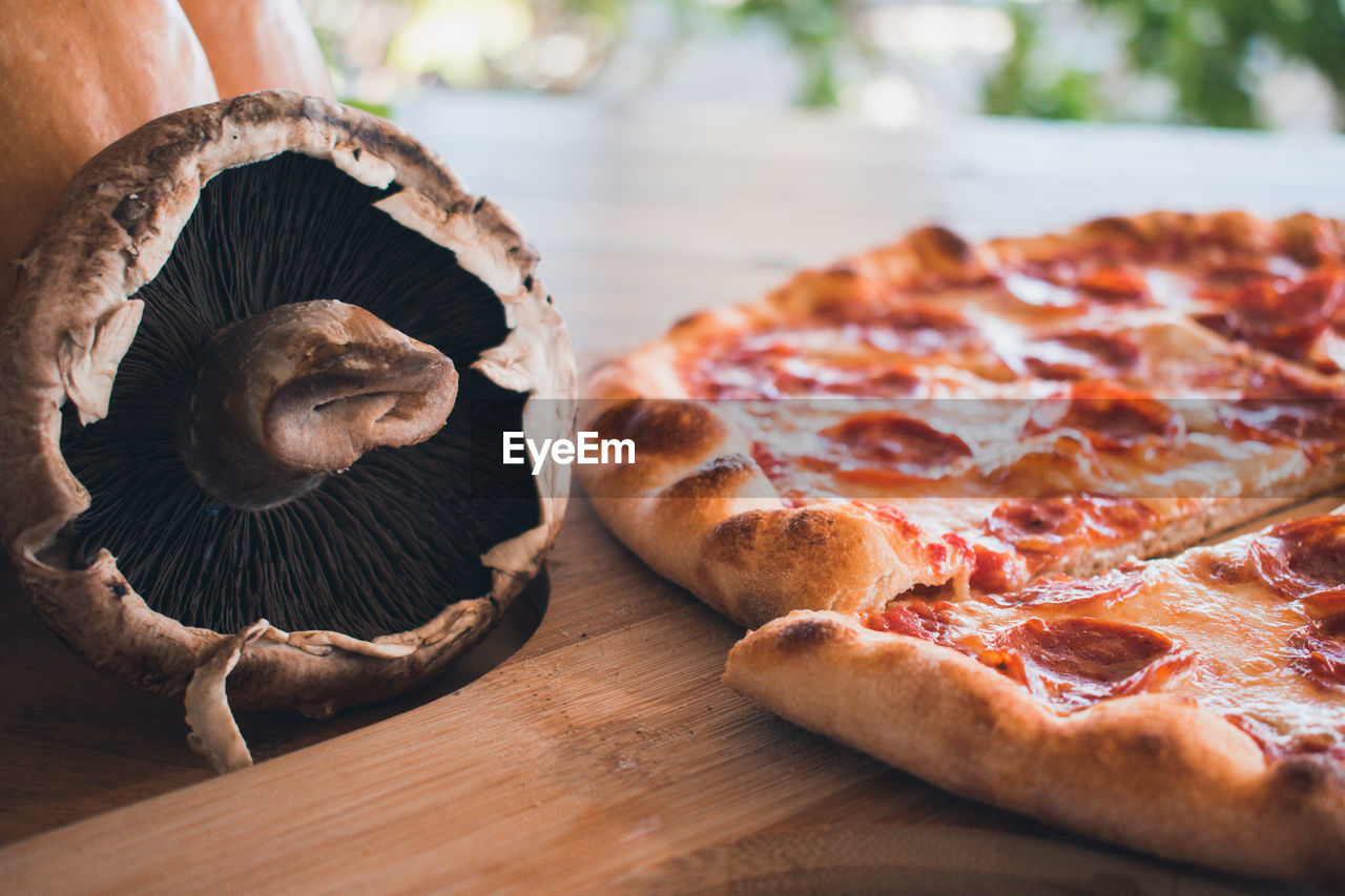 CLOSE-UP OF PIZZA ON WHITE TABLE