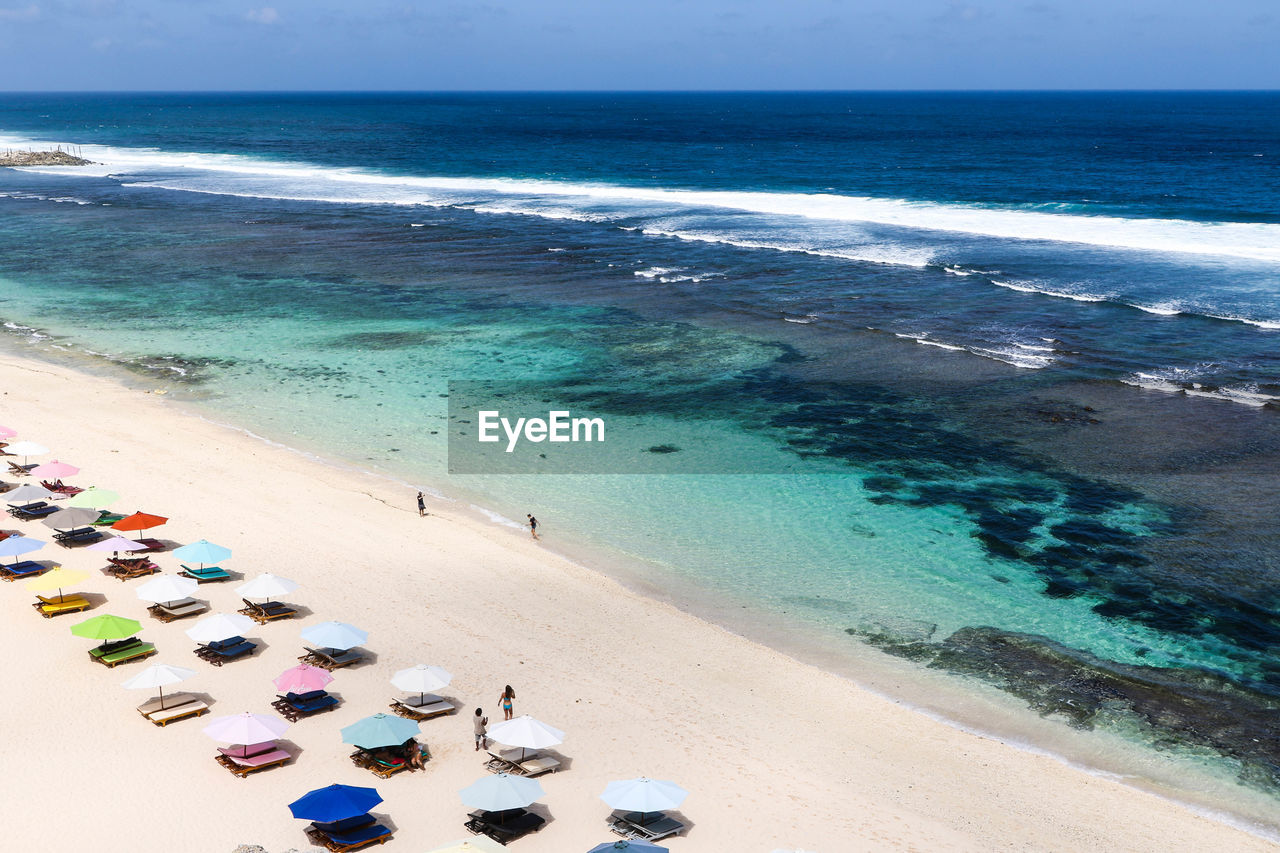 High angle view of parasols at beach against sky