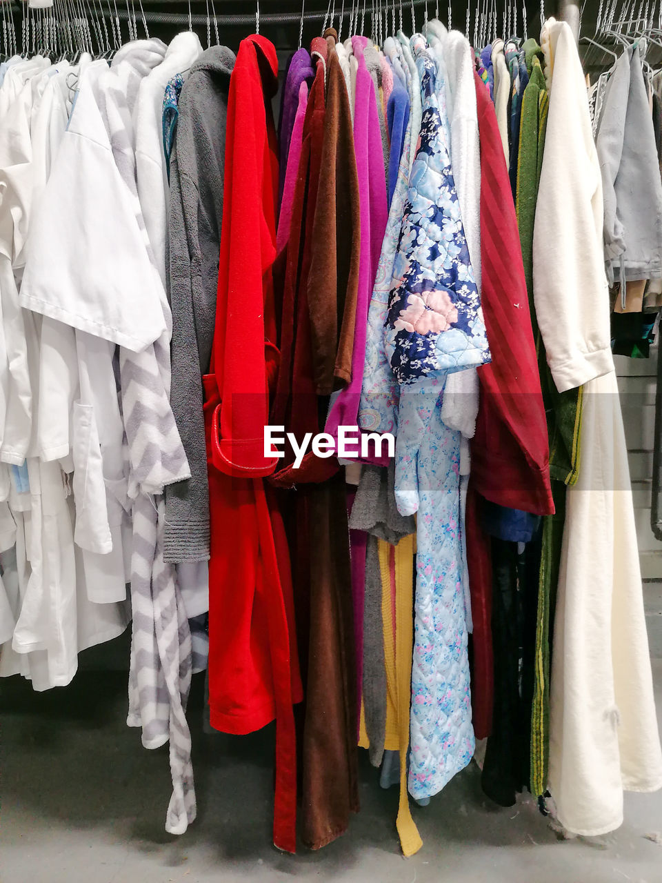 Clothes hanging in a row at store