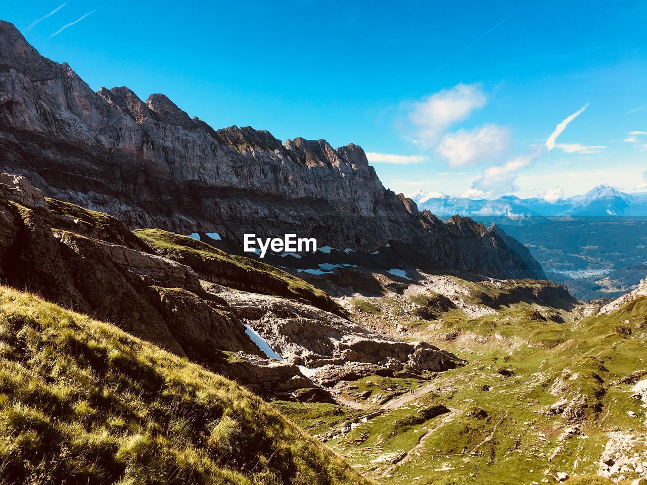 Scenic view of mountains against blue sky