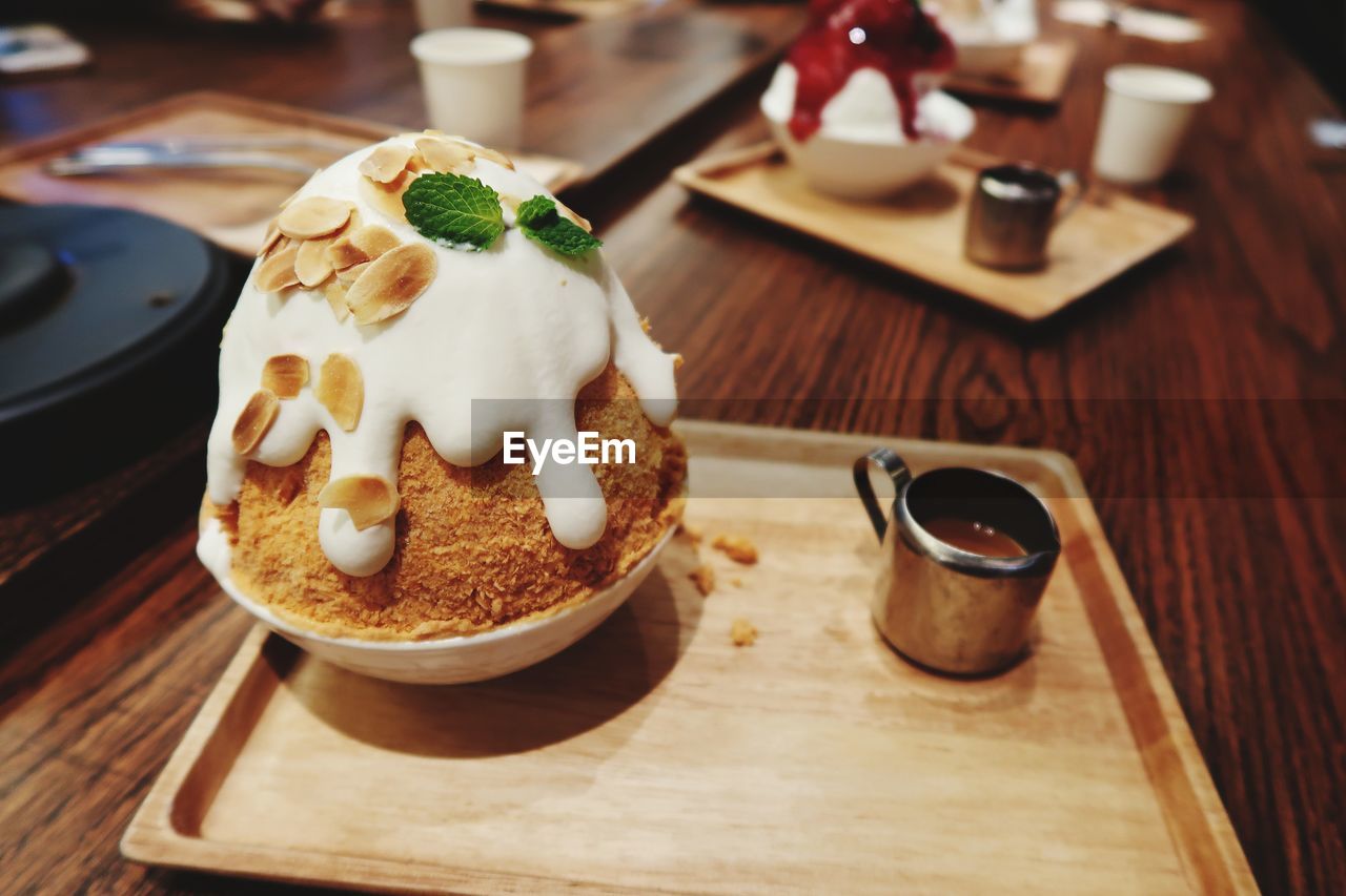 CLOSE-UP OF ICE CREAM SERVED ON TABLE WITH SPOON