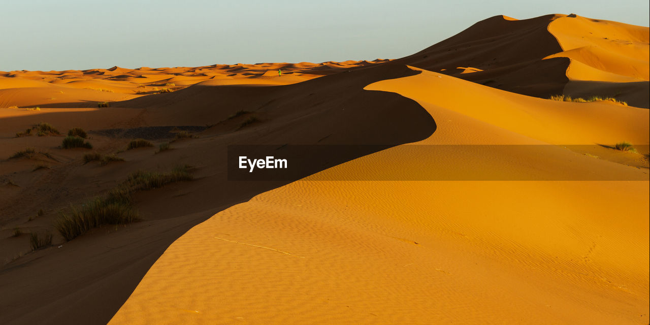 Scenic view of desert against clear sky