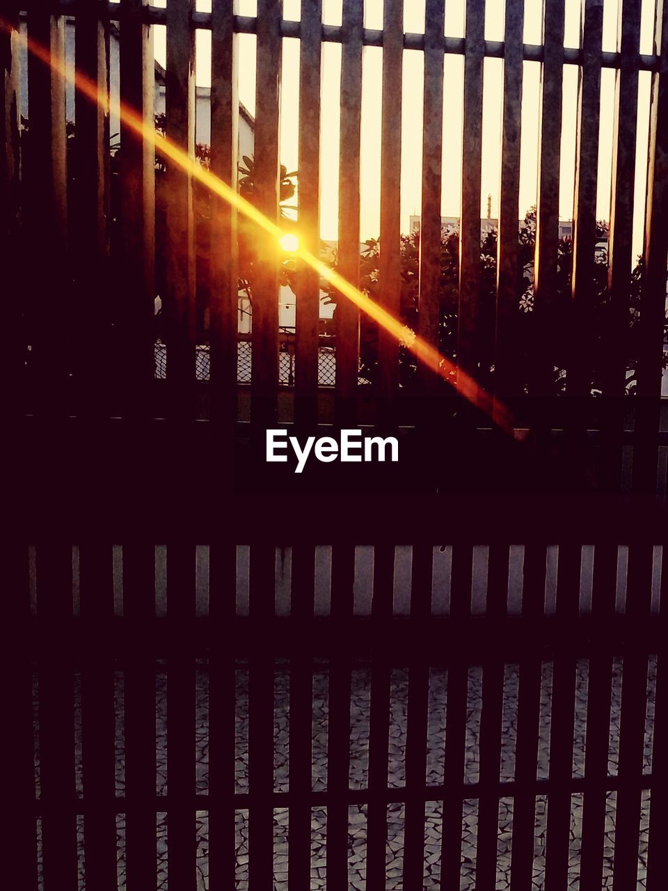 View of fence at sunset