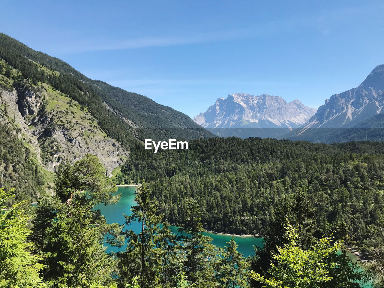 Scenic view of lake and mountains against sky