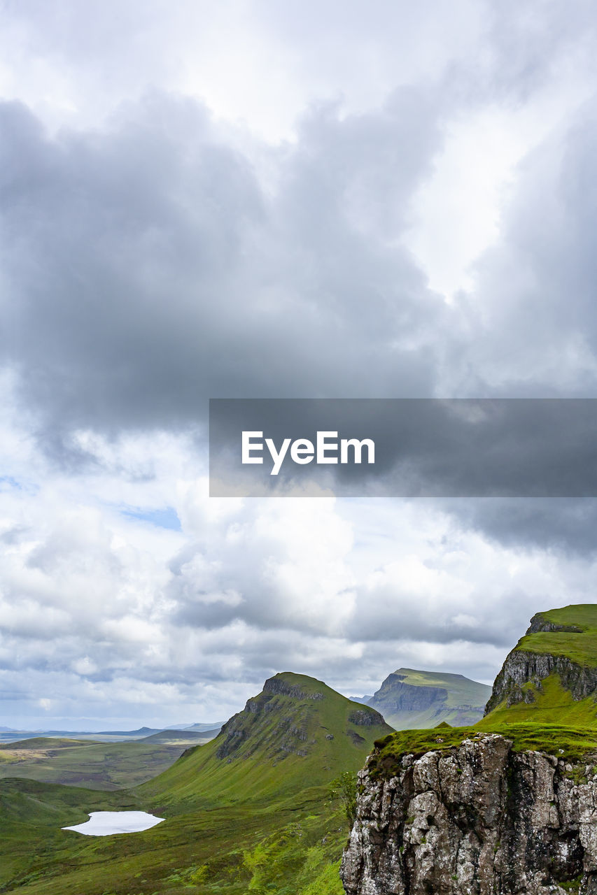 Lake, cliff, sky with clouds in quiraing isle of skye scotland