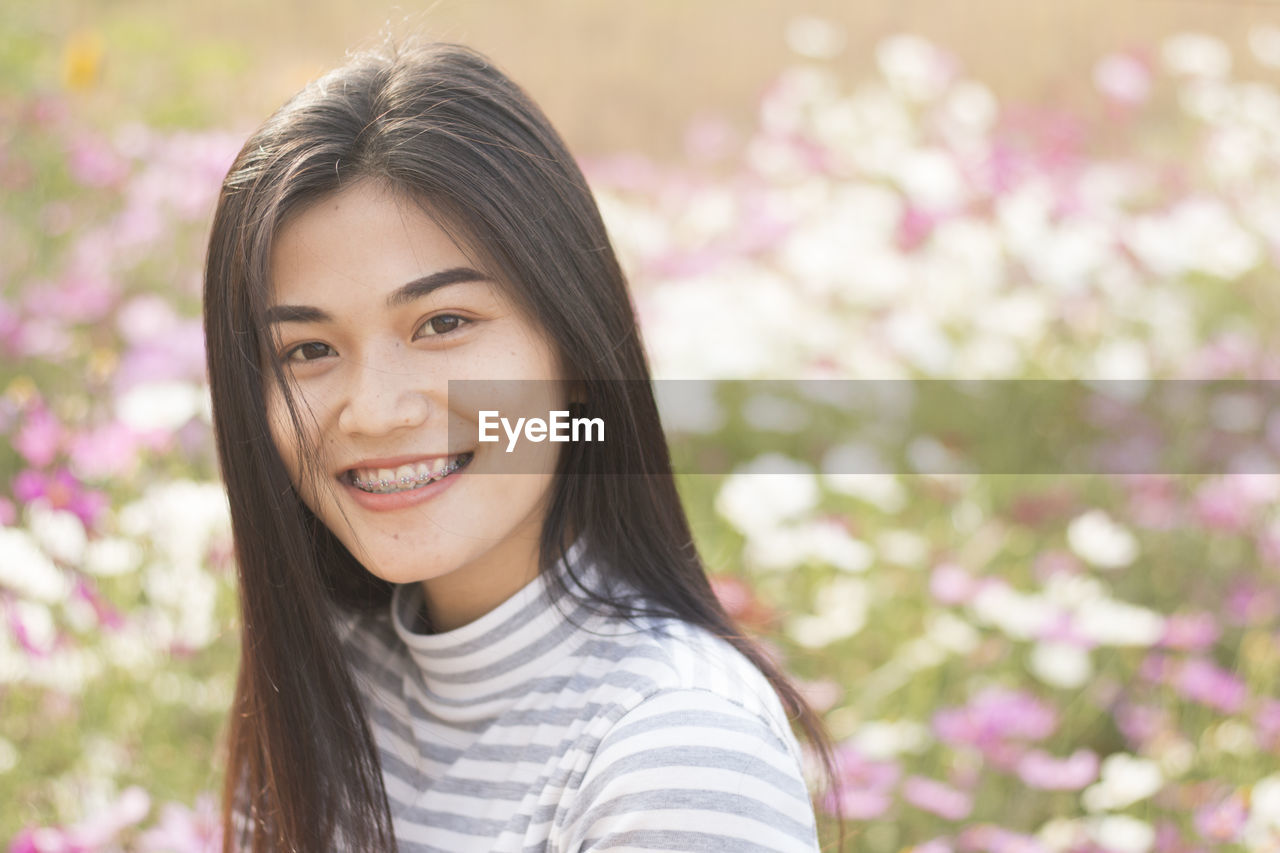 Close-up portrait of young woman at park