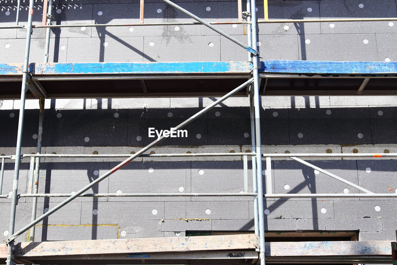 HIGH ANGLE VIEW OF RAILING BY PIER AGAINST BUILDING