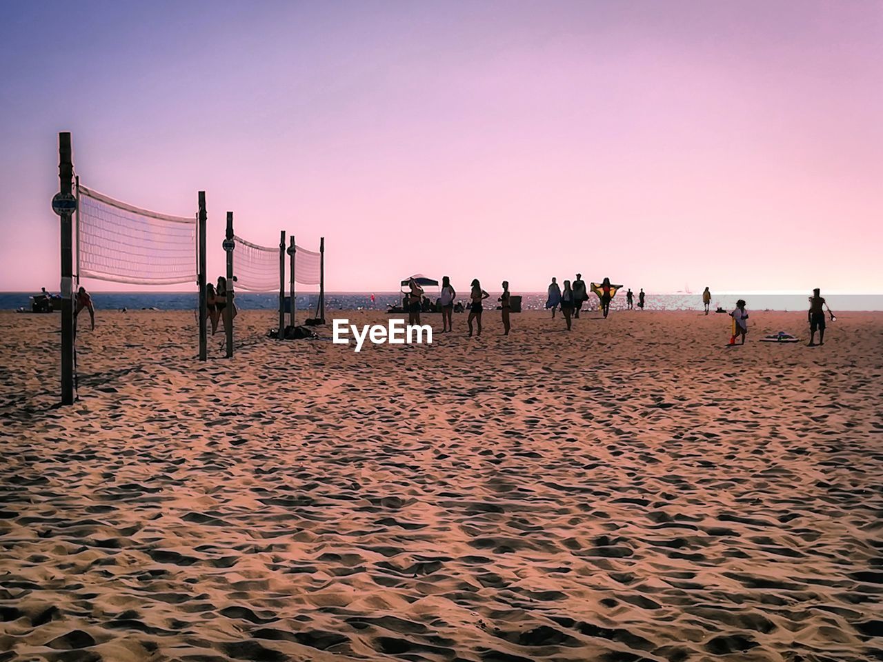 PEOPLE ON BEACH AGAINST CLEAR SKY