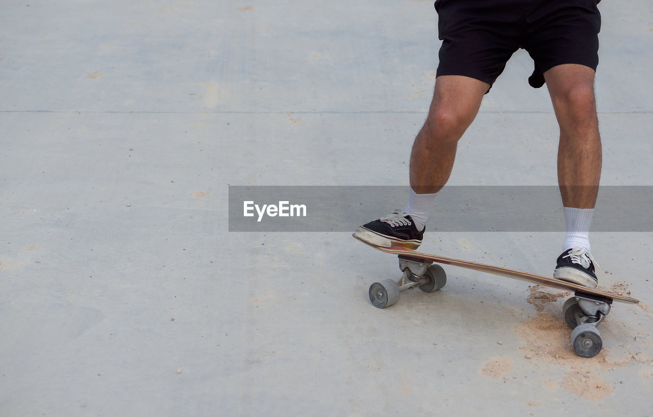 Low section of man skateboarding on skateboard