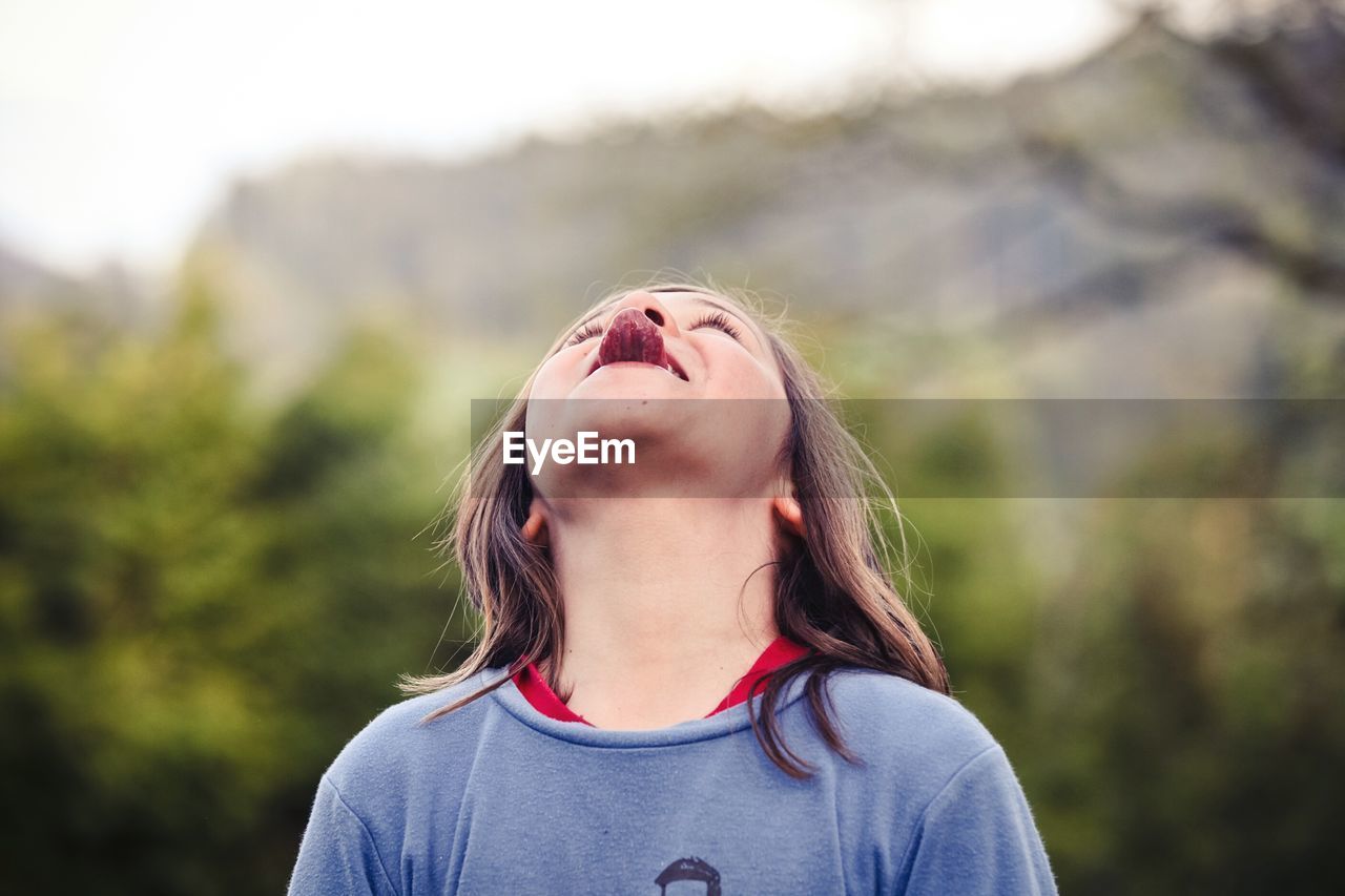 Close-up of a boy sticking out tongue