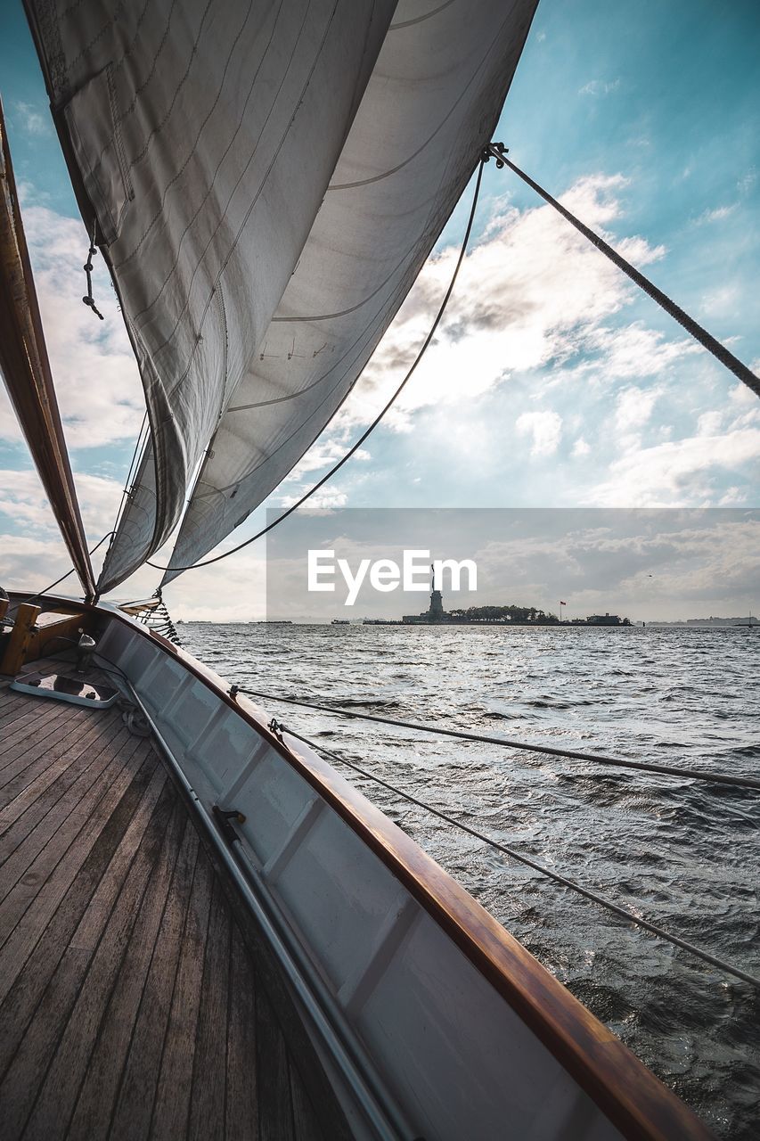 Sailboat sailing in sea against sky