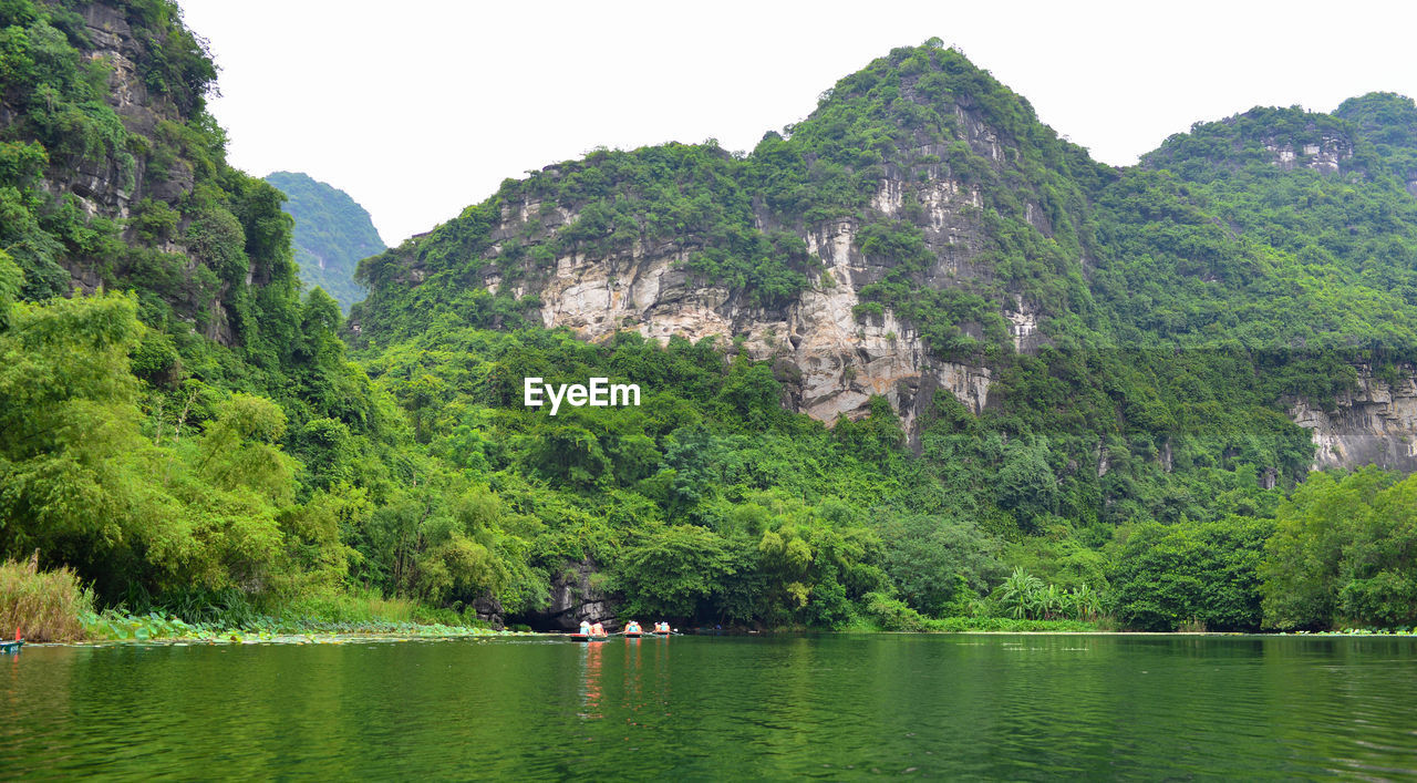 SCENIC VIEW OF LAKE AMIDST TREES AGAINST SKY