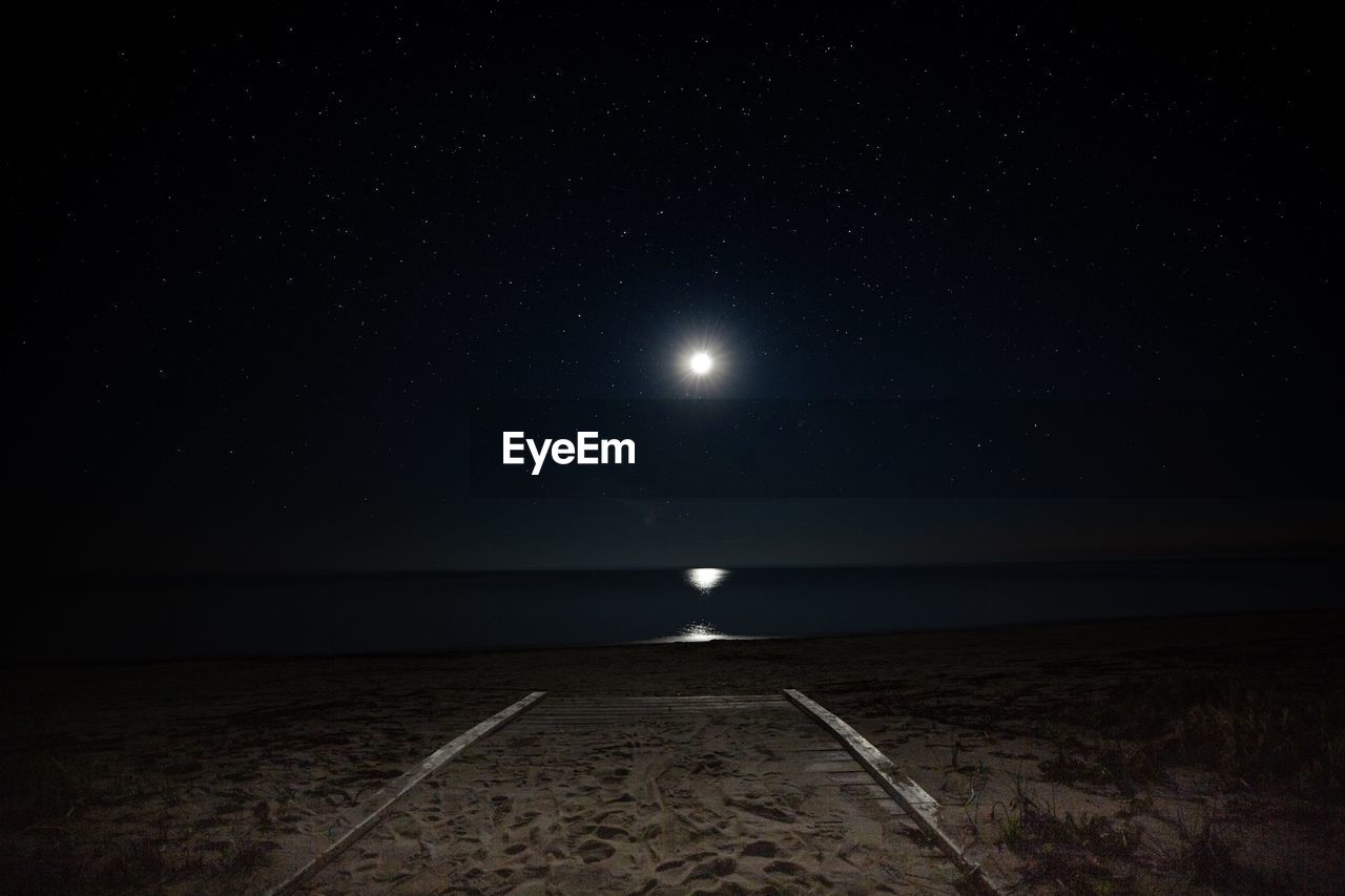 Scenic view of sea against sky at night