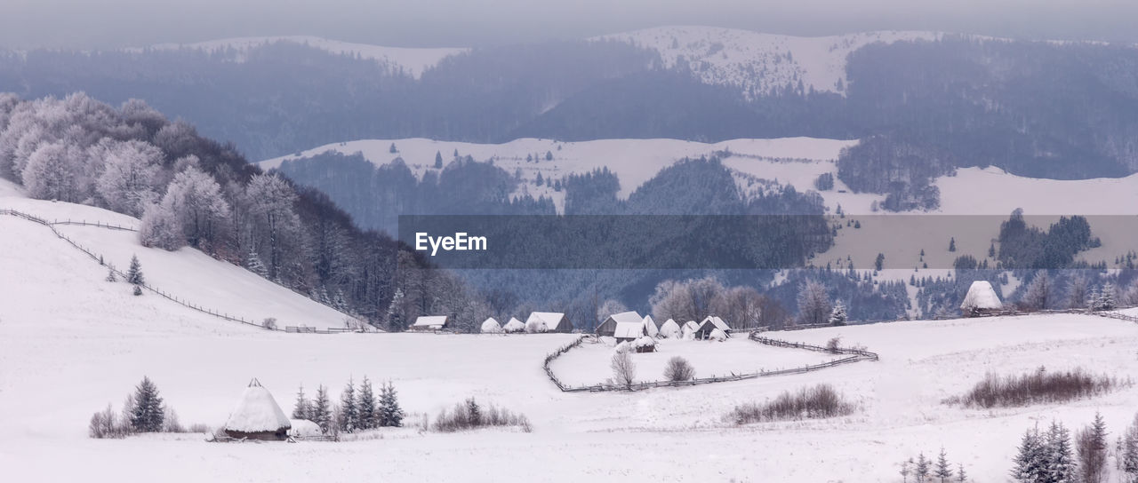 Scenic view of mountains against sky during winter