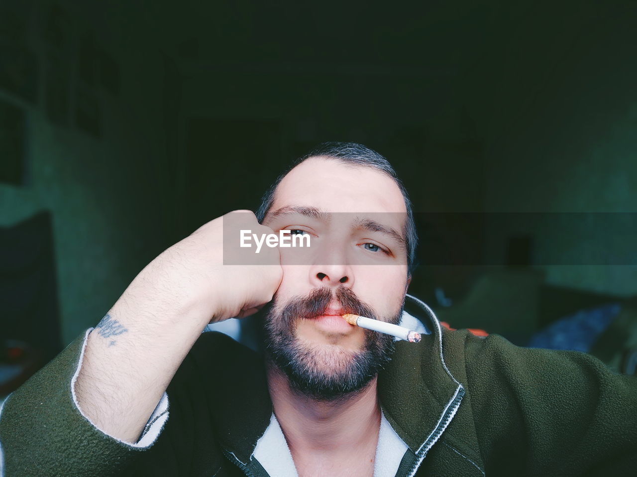 PORTRAIT OF A YOUNG MAN SMOKING CIGARETTE