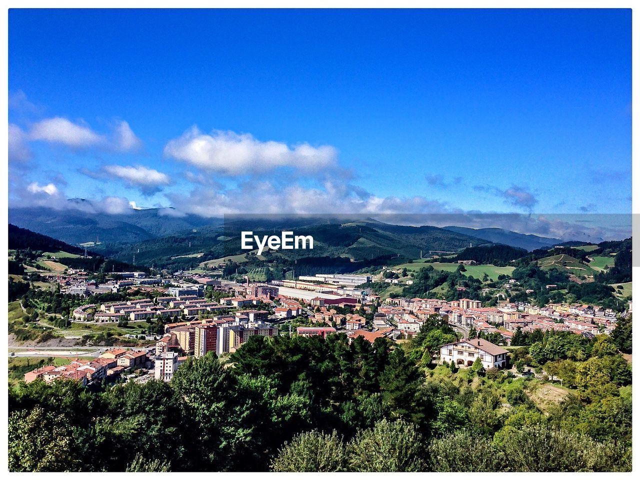 High angle view of city against cloudy sky