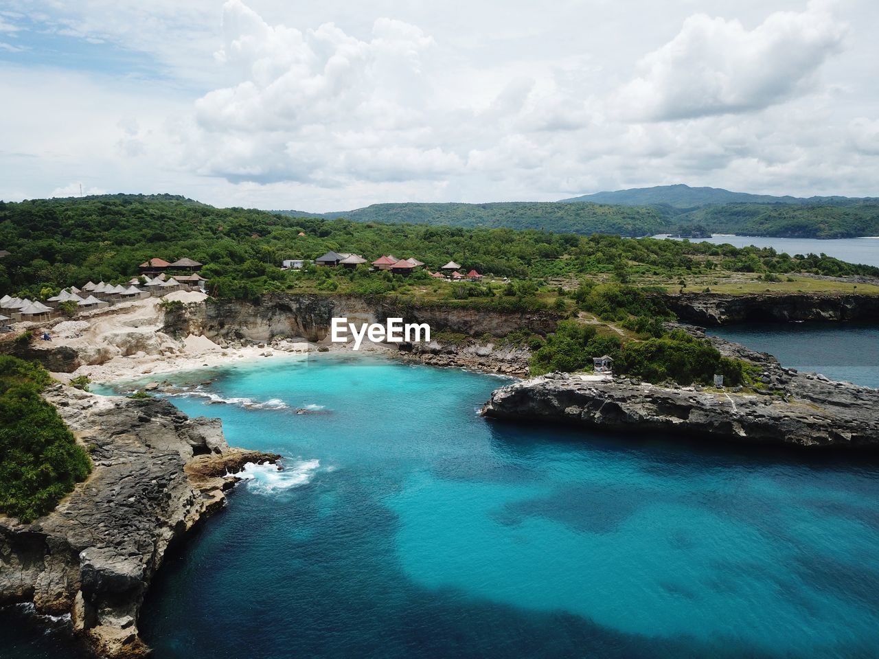 High angle view of sea by landscape against sky