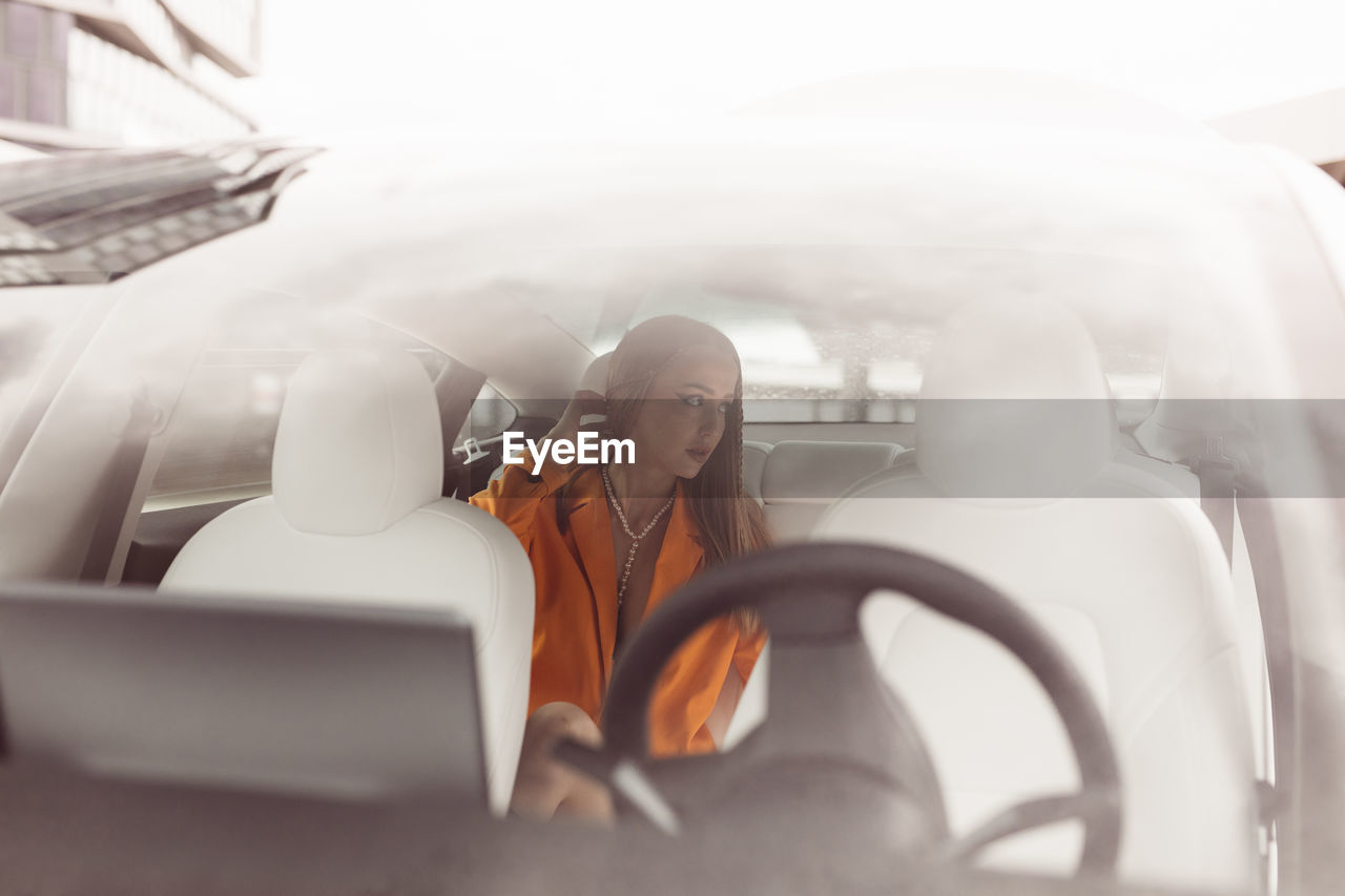 Rear view of woman sitting in car