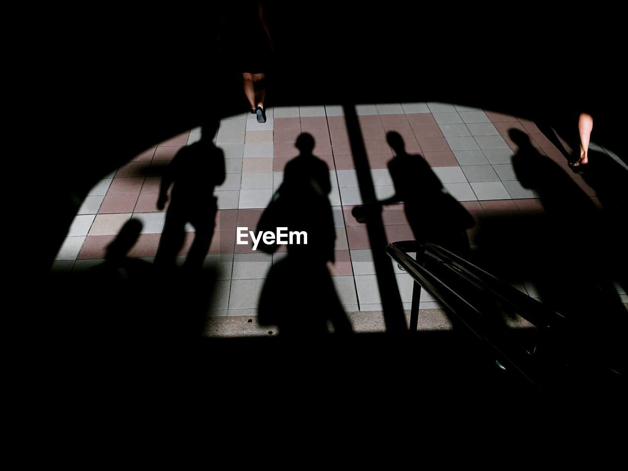 Shadow of people on tiled floor