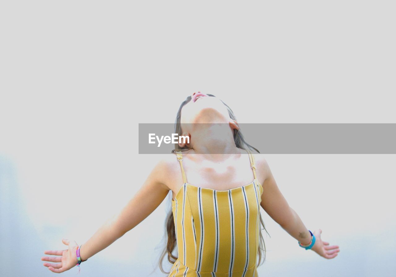 Girl standing against clear sky