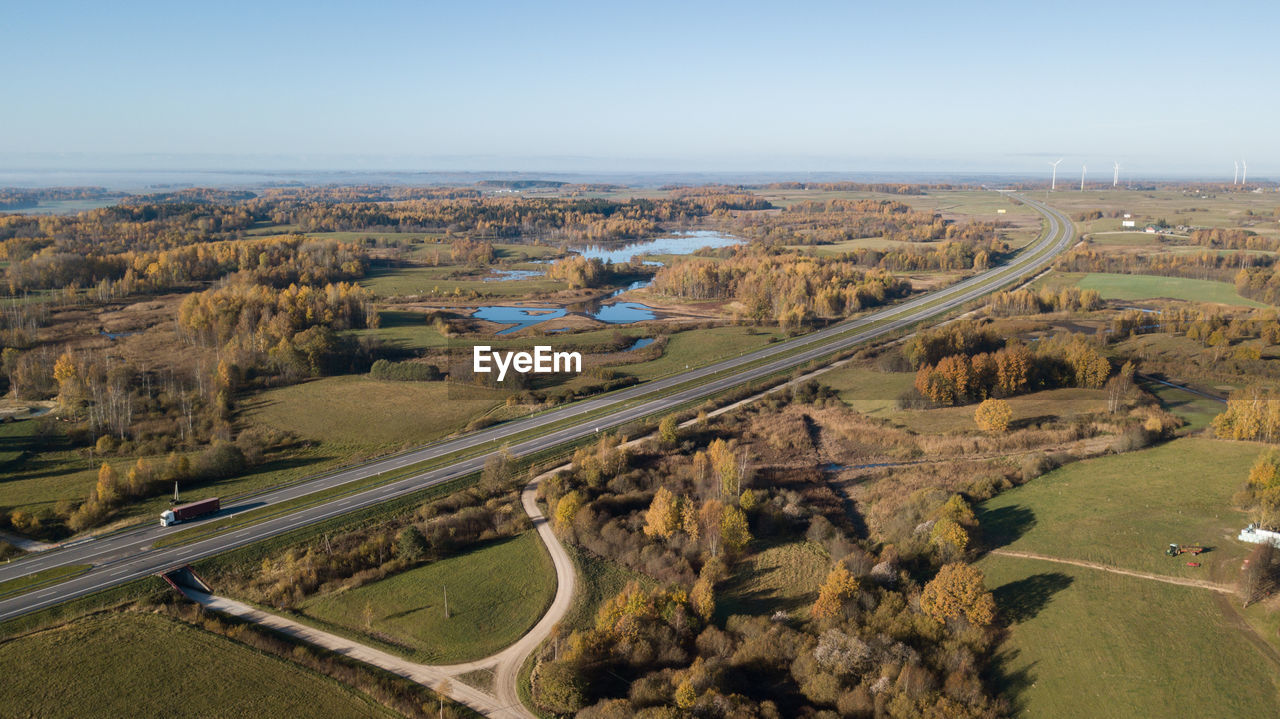 HIGH ANGLE VIEW OF ROAD PASSING THROUGH LANDSCAPE