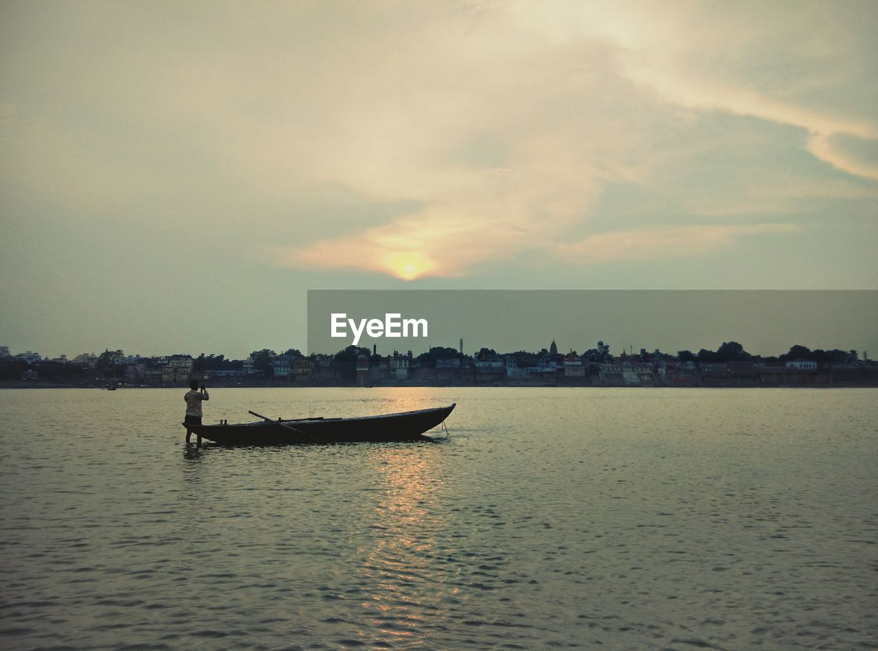 Lone boat in calm lake against the sky