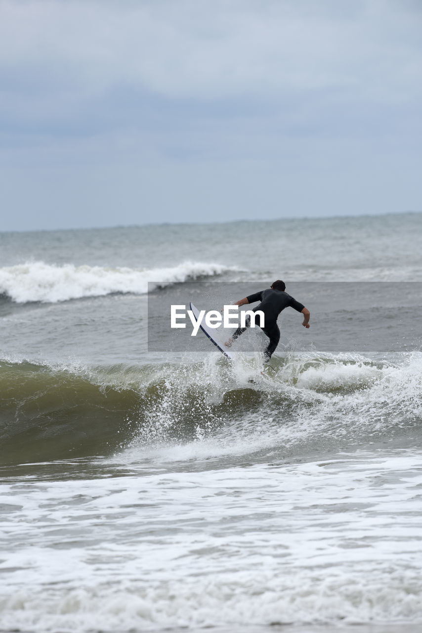 MAN SURFING IN SEA